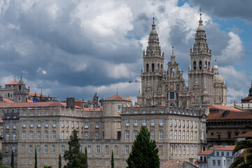 Distant view of Santiago de Compostela Cathedral and surrounding buildings on a cloudy day. Facade of the Obradoiro. Monumental site.