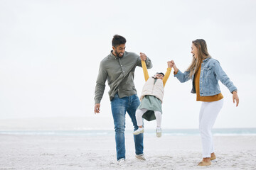 Swinging, holding hands and a family at the beach for walking, bonding or playing together. Happy, playful and a mother, father and boy kid at the ocean for a holiday, relax and love during travel