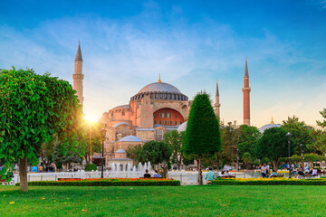 Famous Hagia Sophia Mosque (Ayasofya) at summer sky with cloudy dahlia flowers in Sultanahmet Park,...