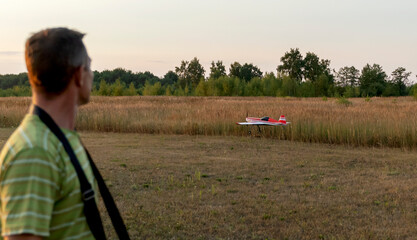 Kosterevo, Russia, August 04, 2022: Father and son launch radio-controlled aircraft models