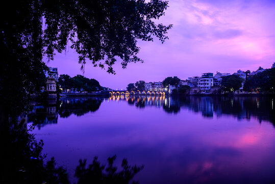 view of arch bridge during dawn at udaipur pichola lake in india