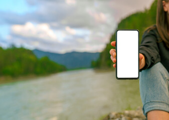 Person showing mobile phone outdoors