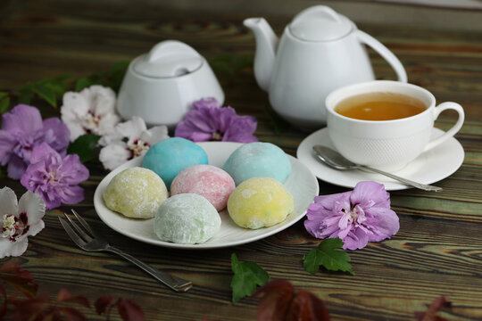 Colorful japanese sweets daifuku or mochi. Sweets close up on the plate with cup of tea
