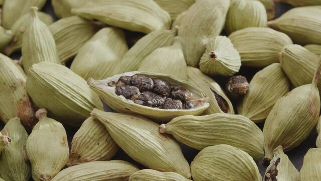 Lots of cardamom spices slowly scroll clockwise, macro video footage. A great background for your projects.