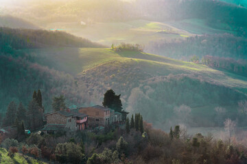 Winter Scene of a Tuscan Cottage, Rolling Hills, and Mist © jeferstellari