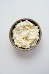 Top view of cottage cheese or queijo fresco in bowl on the white background