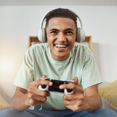 Happy, game controller and man with headphones, listening or relax on a sofa, connection or internet. Person, gamer or guy playing online, home or headset with sound, happiness or console for esports © Mumtaaz D/peopleimages.com