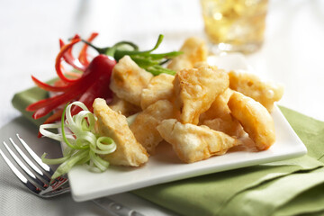 Crispy Delights: A Photorealistic Image of Golden Brown Fried Food, Garnished with Chili Peppers and Green Onions