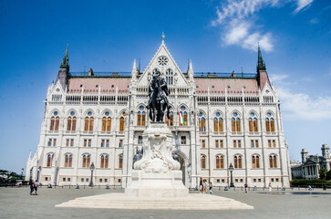 Fototapeta premium Budapest, Hungary, August 15, 2023. Facade of Budapest Parliament and Bronze Monument.
