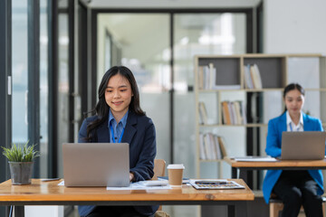 Two Businesswomen collaboration discussing working analyzing with financial data and marketing growth report graph in team presentation and brainstorming to strategy planning making profit of company