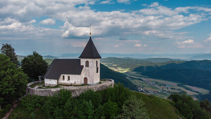Fototapeta na wymiar Church Saint Lawrence at the top of Mount Polhov Gradec aka Mount Saint Lawrence Hill in the Polhov Gradec.