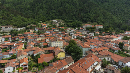 Fototapeta na wymiar Aerial View of Vipava Town, Slovenia. Red Roofs and Forest Covered Hills in the Background
