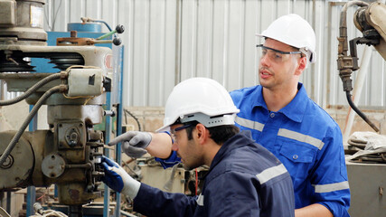 Engineers perform maintenance on industrial machinery.