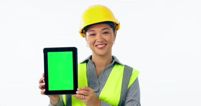 Engineering woman, tablet green screen and industrial presentation for renovation, architecture or design in studio. Face of construction worker or asian person on digital mockup and white background