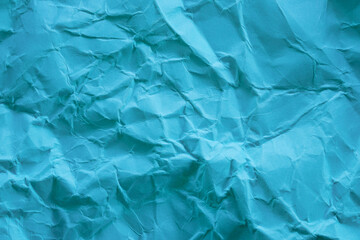Wrinkleed and textured blue paper with multiple creases