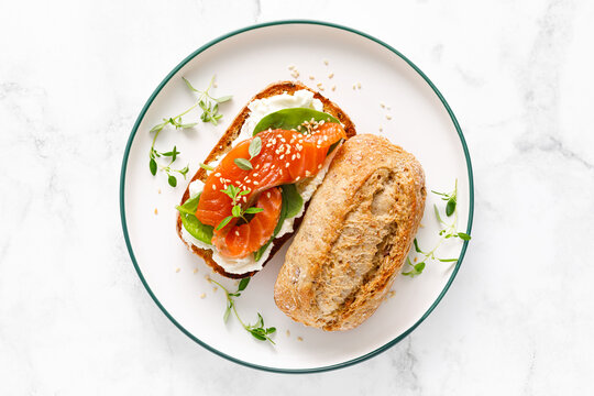 Salmon salted sandwich with spinach and cream cheese, top down view