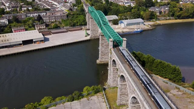 Aerial 4K drone footage of trains going over Boyne Viaduct in Drogheda in Ireland, Summer