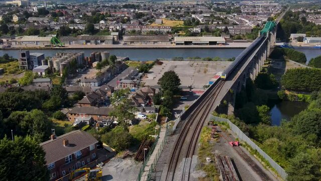 Aerial 4K drone footage of trains going over Boyne Viaduct in Drogheda in Ireland, Summer
