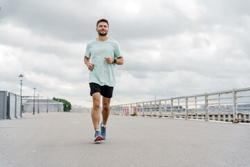 Warm-up man confident interval training. An athlete running in sportswear jogging. Psychological...