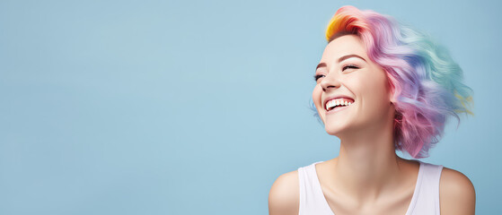 Young beautiful smiling happy woman with rainbow colored wavy hair isolated on flat blue background with copy space, banner template of Creative hair coloring.