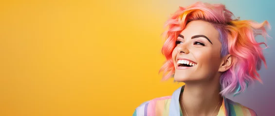  Young beautiful smiling happy woman with rainbow colored wavy hair isolated on flat yellow background with copy space, banner template of Creative hair coloring. © SnowElf