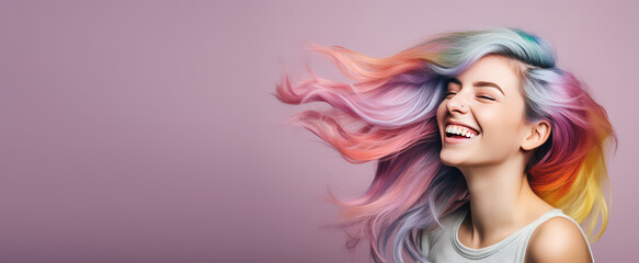 Young beautiful smiling happy woman with rainbow colored wavy hair isolated on flat purple background with copy space, banner template of Creative hair coloring.