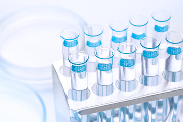 Scientific laboratory test tubes with light blue liquid, closeup. Laboratory, equipment