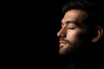 Close up face Caucasian handsome man isolated on black background Handsome man close eyes in studio...