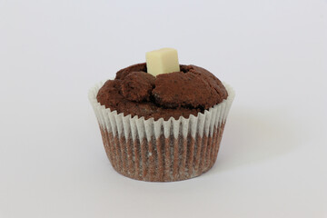 Chocolate muffins on white background. Homemade fluffy and moist chocolate cakes. Isolated