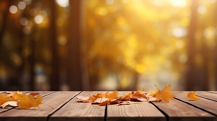 Naklejka na ściany i meble Wooden planks and orange dry leaves against the backdrop of blurred tree foliage in a picturesque autumn park. This versatile autumn background is suitable for presentations and various design purpose