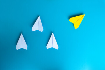 Top view of white and yellow paper airplane. With space for text.