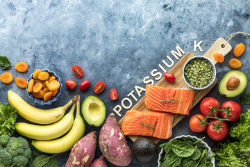 An assortment of foods high in potassium with copy space above.