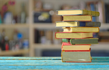 Stack of books with blurred bookshelf background, reading,literature,learn, education,...