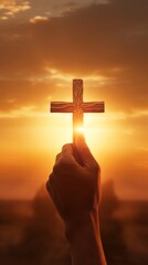 A person holding a cross against a breathtaking sunset backdrop