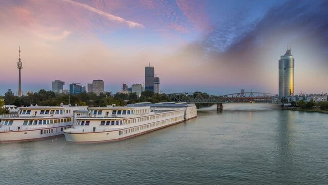 Vienna skyline aerial view time lapse of vienna city austria view of riber and bridge river donau,in front vienna skyscrapers tv tower and buildings. Vienna night day timelapse