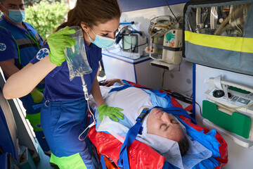 Patient lies on a stretcher in an ambulance © Svitlana
