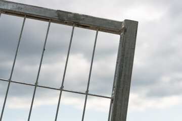 metal barrier fence and cloudy sky