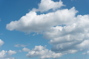 Naklejka na ściany i meble blue sky with fluffy soft white clouds