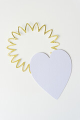 textured paper heart and spiral or floral frame on blank paper