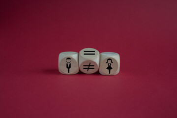 Concept of gender equality. Turned a cube and changed a unequal sign to a equal sign between symbols of men and women. Beautiful red background, copy space.