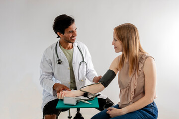 Doctor measuring blood pressure on a woman