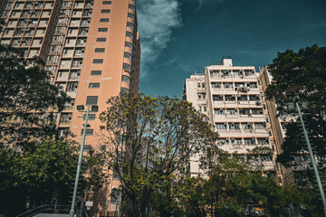 Gazing up at two distinct residential buildings, with the left being a public housing estate and the right being a privately-owned traditional residential building