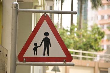  Sign indicating adults leading children near the school