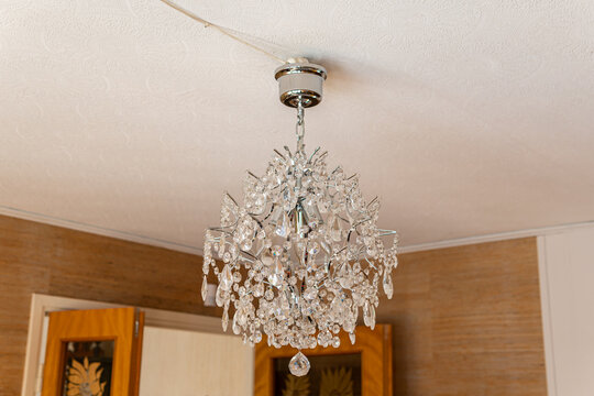 Old vintage lead glass hanging pendant lamp in a room. Cozy and warm sunlight.