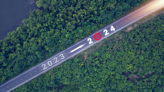 New year 2023 or 2024, planning concept, start of success, text 2024 written in the middle of a paved road. New year plans, goals, challenges, resolutions.