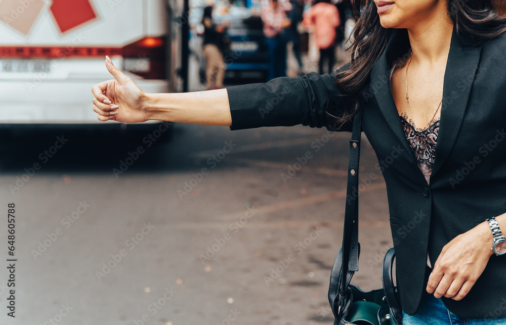 Wall mural Woman stopping a vehicle at a bus stop