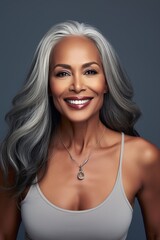 Portrait of an adult woman with long gray hair and white teeth