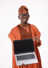 businessman showing laptop screen happy excited Handsome happy smiling excited African black man in late 20s isolated on a white background holding laptop PC wearing Yoruba Nigerian native tradition
