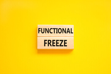 Functional freeze symbol. Concept words Functional freeze on beautiful wooden blocks. Beautiful yellow table yellow background. Business psychology functional freeze concept. Copy space.