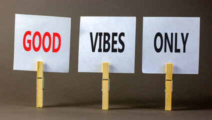Good vibes only symbol. Concept word Good vibes only on beautiful white paper on wooden clothespin. Beautiful grey table grey background. Business motivational good vibes only concept. Copy space.